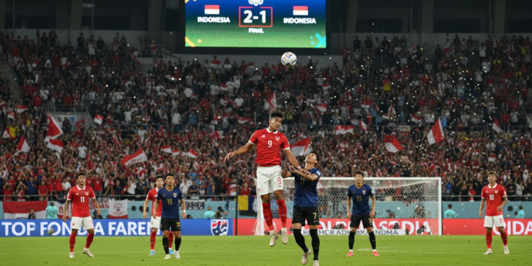 Pramono Prediksi Indonesia Raih Kemenangan 2-1 atas Thailand di Final FIFA ASEAN Cup 2026 A high-energy soccer match between Indonesia and Thailand at the final of FIFA ASEAN Cup 2026, with players in action, fans cheering, and the Gelora Bung Karno stadium in the background, reflecting the tension and excitement of the moment.