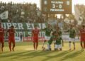 Rossy Timur Hadiri Peresmian Patung Mayjen (Purn) Andi Mattalata PSS Sleman players celebrate their victory over PSM Makassar in a Super League match. The stadium crowd, predominantly supporting PSS Sleman, watches as the final score is 3-0. PSM Makassar players lo