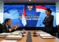 Kemenkumham Sulbar: Implementasi Nyata Rekomendasi Reformasi Hukum, Bukan Sekadar Formalitas Administratif Sebuah debat hangat antara eks Ketua KPU, Hasyim Asy'ari, yang duduk dengan berkas-berkas di meja, dan anggota DPR yang berdiri, bergerak-gerak dengan ekspresi serius. Latar belakang menampilkan layar