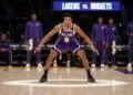 Jaga Kebugaran Tubuh, Orange Muda gelar Fun Bike Ditengah Pandemi Covid 19 Ziaire Williams, a confident basketball player, stands on the court with the Lakers' bench area in the background, ready to start the game against the Nuggets. The stadium lights create a focused and
