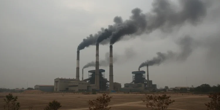 ISPU Muaro Jambi Capai 228, Tebo Catat 185 A depiction of an industrial complex with multiple smokestacks emitting dark smoke, symbolizing high levels of air pollution in Muaro Jambi. The sky is overcast, and the ground is covered with dust, w
