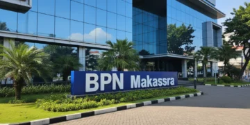 The image shows the exterior of BPN Makassar's office building with a modern design, glass facades, and a signboard reading 'BPN Makassar'. The building is set in a well-lit urban area with clear skie