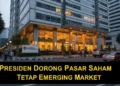 Fadel Muhammad Gantikan Hashim sebagai Komisaris Utama WIFI The image shows the modern OJK building in Jakarta, illuminated by evening lights, with the Indonesian national flag and a signboard reading 'Presiden Dorong Pasar Saham Tetap Emerging Market', symbol