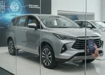 A modern car dealership showroom displaying the latest Toyota Kijang Innova Zenix, with a smartphone being used to activate the vehicle's ignition, highlighting the car's advanced technology and user-