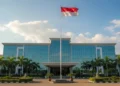 Samsung Galaxy Book tablet Penantang Microsoft Surface The Merauke Regent's office building with a national flag waving in the wind, surrounded by neatly trimmed greenery, symbolizing the regent's encouragement for santri to be both academically and techn