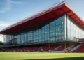 St. Mary's Stadium, Bournemouth Football Club, with its red and white striped banners and modern architecture, set against the English countryside, preparing for the match against Milan.