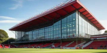 St. Mary's Stadium, Bournemouth Football Club, with its red and white striped banners and modern architecture, set against the English countryside, preparing for the match against Milan.