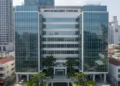 BI Ungkap Biang Kerok Rupiah Loyo Tembus 17.900/USD: Konflik Timur Tengah Hingga Kebutuhan Dolar Meningkat A modern office building with sleek glass facades and a signboard displaying 'UMKM Management Strategies' in a bustling business district. The interior is well-lit and decorated with green plants and