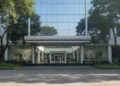 Pertama Kali Salju di Gurun Al Jawf Arab Saudi The main building of BMKG in Jakarta, Indonesia, with a modern glass facade and a prominent logo of a globe and wave, symbolizing meteorology, climatology, and geophysics. The interior is bright and o