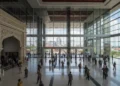 Camat Panakkukang Gelar Rapat Koordinasi di Lorong Wisata A detailed view of the Balai Kota Makassar in Makassar, reflecting the city's bustling activity and modern architecture. The building's large entrance and glass panels are prominently featured, with n