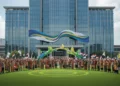 Resmi, Ini Jadwal Libur Sekolah Ramadan 2025 A grand entrance of the Ministry of Tourism (Kemenpar) in Jakarta, with a banner promoting the 'Kemenpar and OGFC Unite 2027' initiative. The background features a soccer field with fans in traditiona