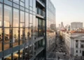 Hakim MK Bertanya soal Ijazah Gibran, Fokus Transparansi Data Pendidikan Il Toro's modern and sleek headquarters with a glass facade and warm interior light, contrasting with Monza's historic and imposing structure with marble columns, symbolizing the economic and business