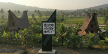 Desa Sumber Pasir is depicted with a QR code signboard at the entrance, integrating modern technology with traditional rural architecture. The scene showcases a harmonious blend of old and new, symbol