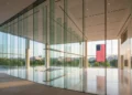 OnePlus 14 Pro: Revolusi Desain dan Fotografi Hasselblad untuk Era Kreator Digital The image depicts the FCC headquarters in Washington D.C., a modern glass building with a spacious lobby and high ceilings, symbolizing the regulatory body's authority over technology. The American fl