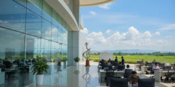 The image depicts the South Sulawesi Provincial Government Office with its modern glass façade and well-organized interior, symbolizing the province's readiness to become a central hub for food produc