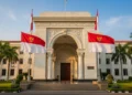 A grand entrance of the Indonesian Defense Ministry with intricate marble pillars and a fluttering national flag, symbolizing the legacy of MA. Untung Widodo AS, the first Chief of the Indonesian Arme