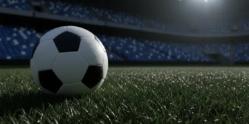 Bola sepak profesional bersandar di rumput basah bawah sorot lampu stadion dramatis pada malam hari dengan latar belakang kursi kosong yang buram menciptakan suasana ketegangan tanpa pemain atau logo